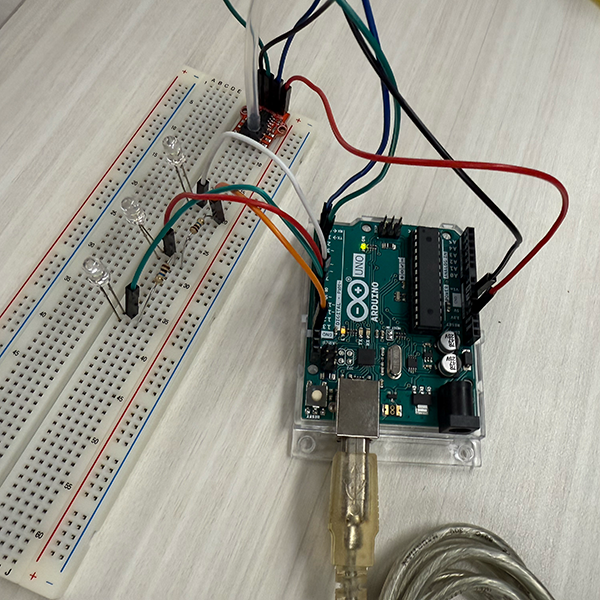 Our first attempt was unsuccessful. We connected the sensor to the Arduino as we had in the previous activity and followed the video to connect the LED lights and assign pin numbers. However, the Arduino setup in the video wasn’t fully shown, so we had trouble figuring out how the grounds were connected. Connecting the negative sides of all three LEDs to a single ground pin was incorrect and caused only one LED to light up.