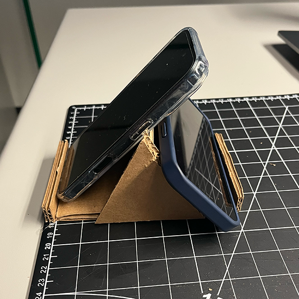 This is the finished design of the second phone stand tutorial. It showcases the final product after following the step-by-step instructions from the video. The design is simple yet effective, demonstrating how guerrilla prototyping can lead to practical solutions with minimal resources and time investment.