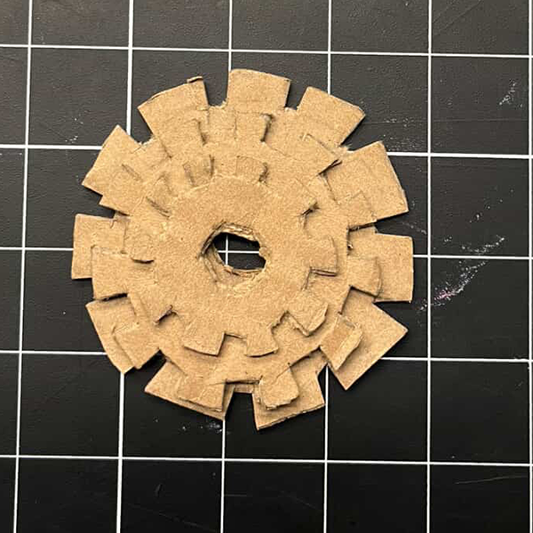 This is what the gears looked like after we cut them out of cardboard. We made sure to create teeth on the gears so they could interlock and rotate together. This step was crucial for testing the functionality of our gear system.